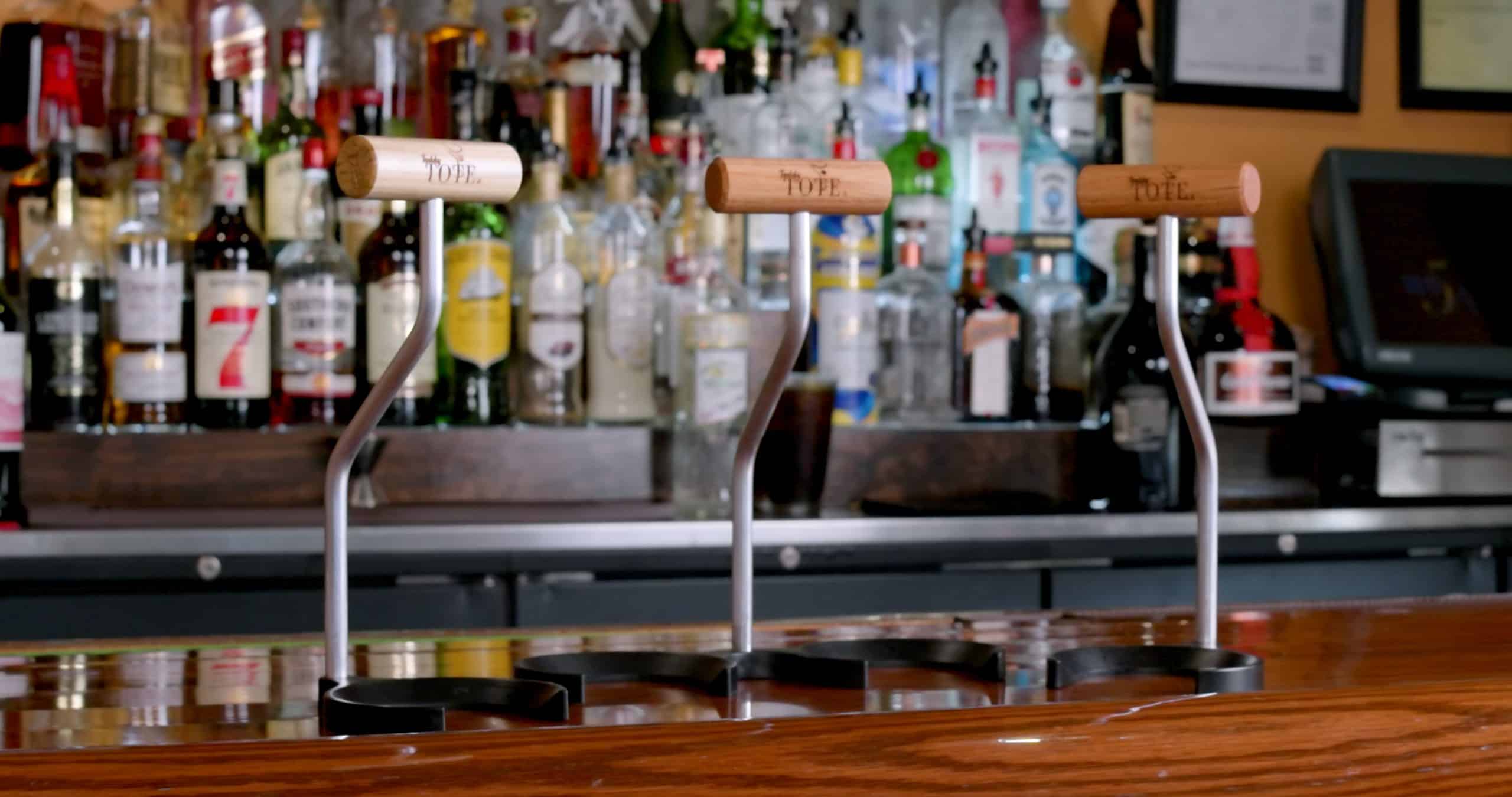 Three Toddy TOTES on a bar top